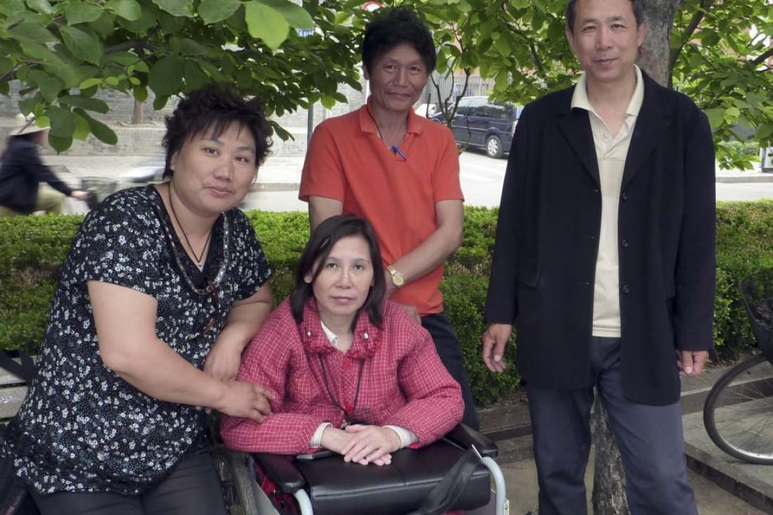 Activist Ni Yulan poses in 2010 with her husband Dong Jiqin (third from left) and friends. Photo: AFP