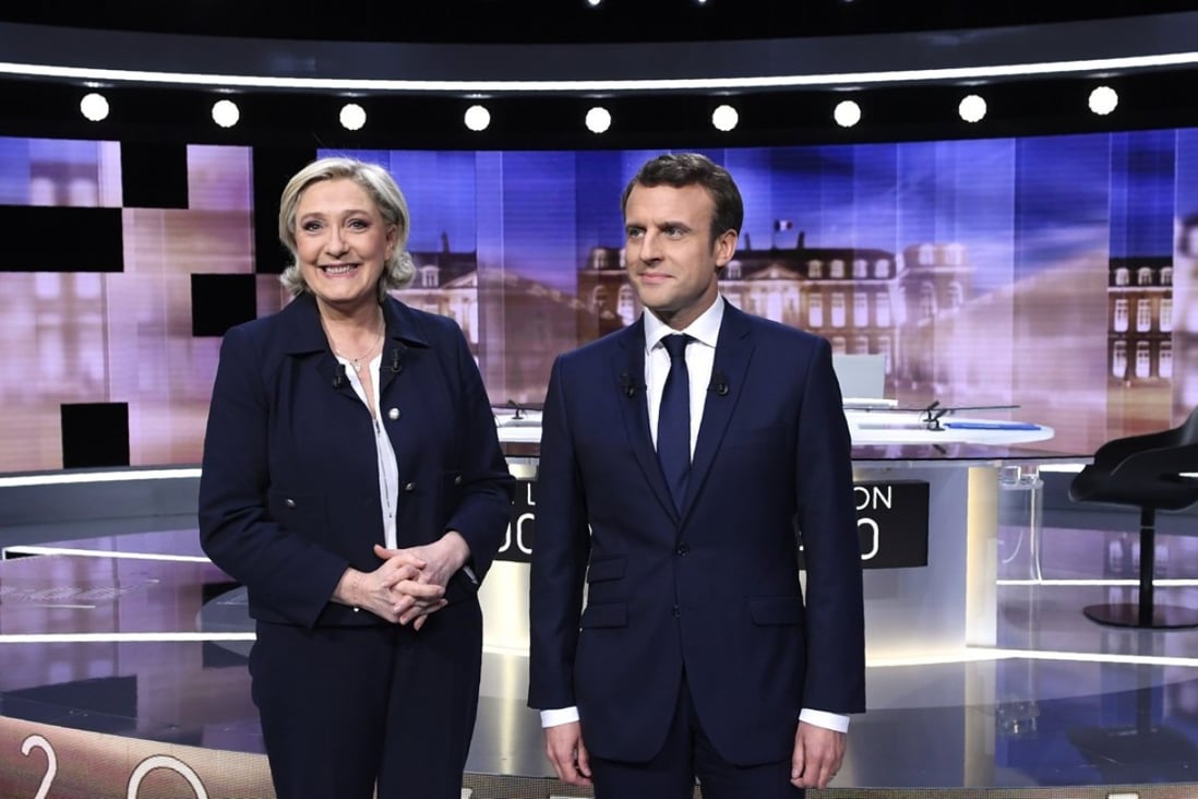 Marine Le Pen (L) and Emmanuel Macron (R) pose prior to the start of the final debate in the French presidential elections where they traded insults. Photo: EPA