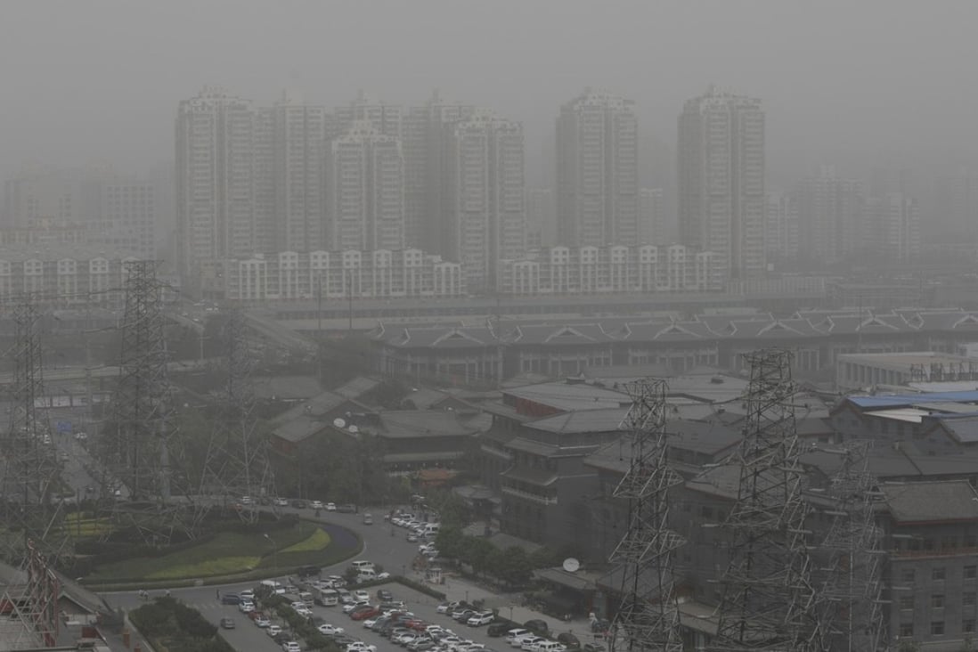 Buildings seen through a heavy sandstorm in Beijing on Thursday. Photo: EPA