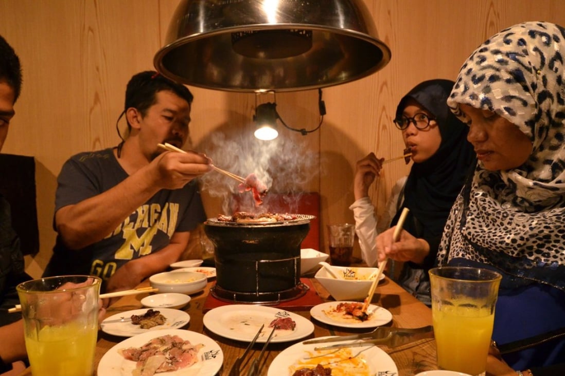 Thai Muslim tourists enjoy halal certified food at a barbecue restaurant in Tokyo. Photo: AFP