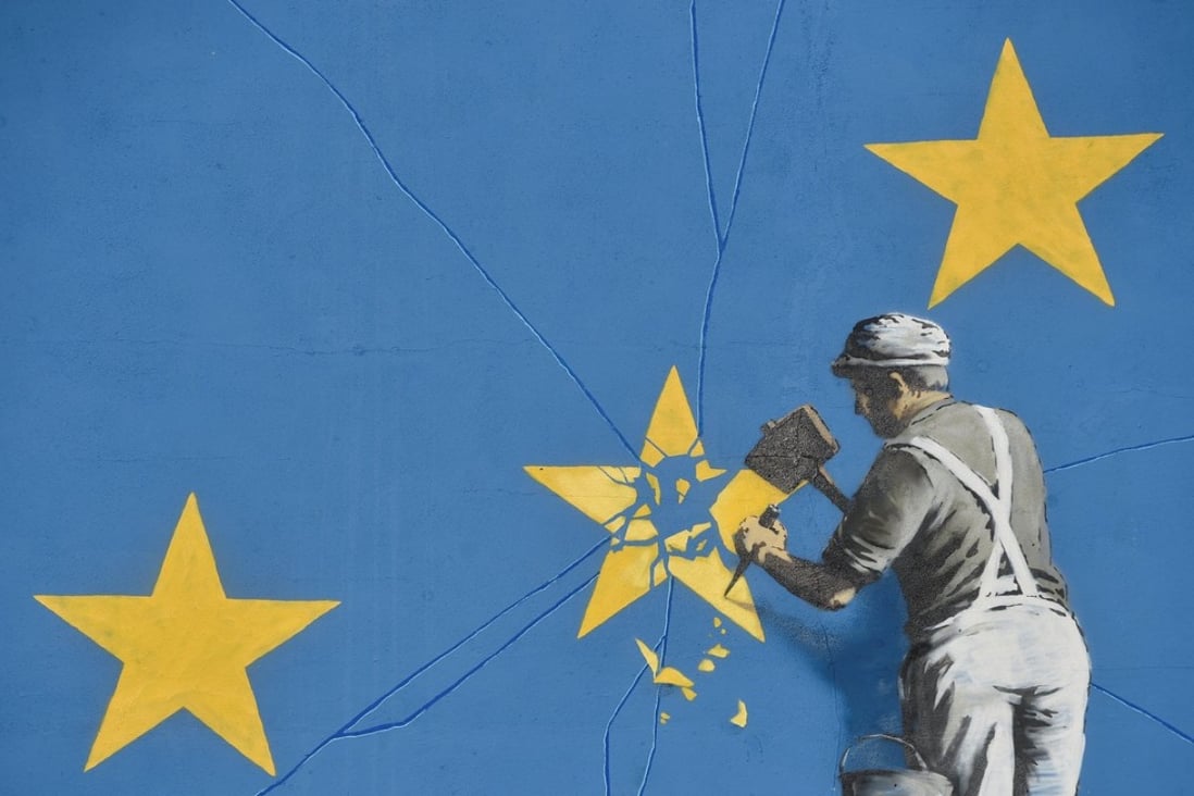 A section of an artwork attributed to street artist Banksy, depicting a workman chipping away at one of the 12 stars on the flag of the European Union, is seen on a wall in the ferry port of Dover, Britain, on Sunday. Photo: Reuters