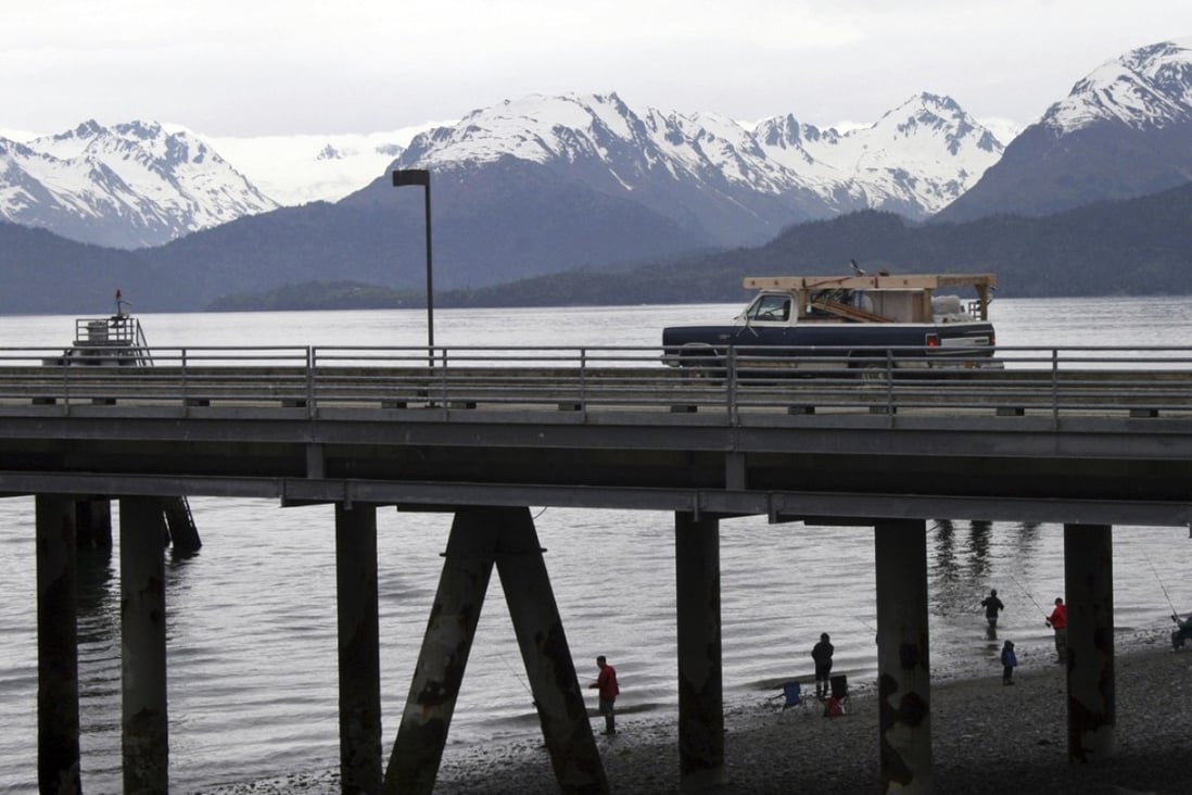 In this May 24, 2015 file photo, a vehicle drives on a pier to be loaded onto an Alaska state ferry while people fish underneath the pier in Homer, Alaska. Warming tundra could be releasing more carbon into the atmisphere, scientists warned. Photo: AP