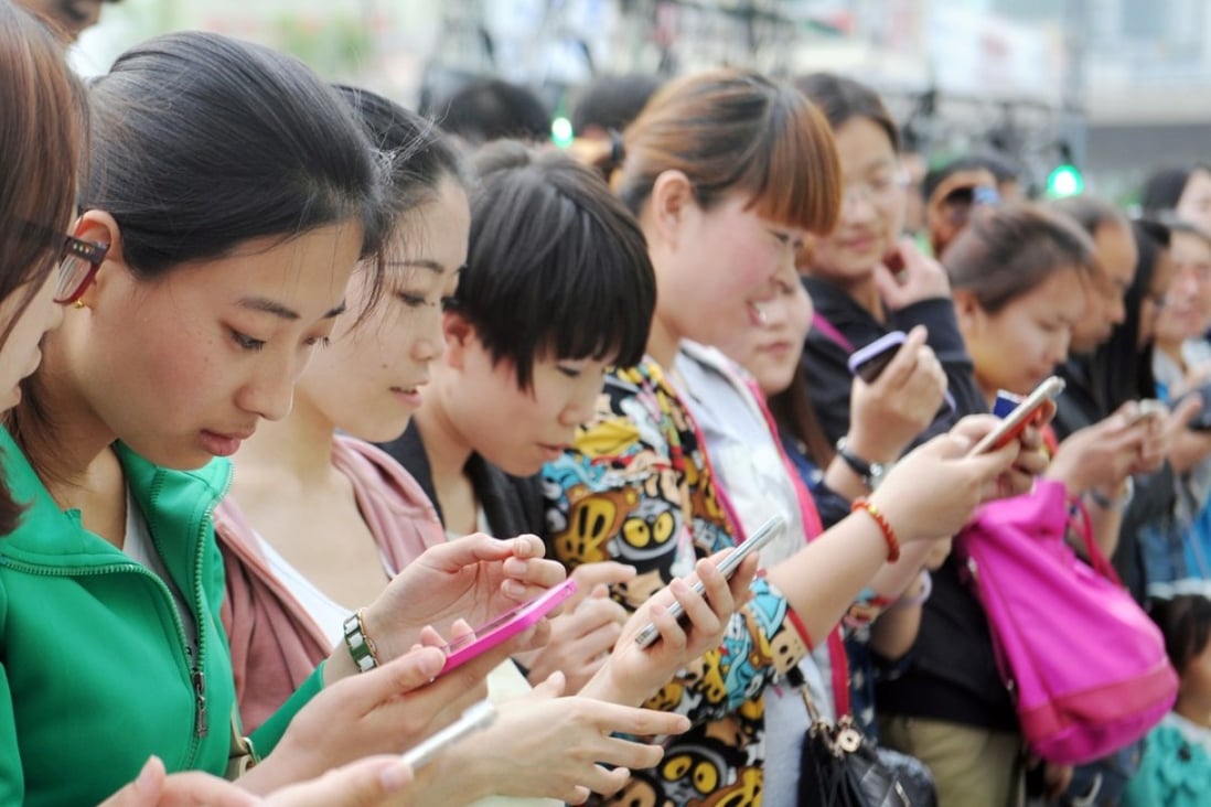 The Chinese on average spend nearly 3 hours a day on their smartphones with social networking tools, watching videos and shopping online. Photo: Imaginechina