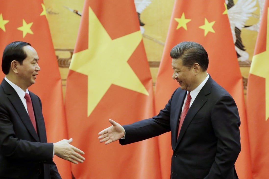 Tran Dai Quang (left) meets Xi Jinping in Beijing yesterday. Photo: EPA