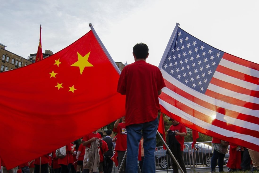 Demonstrators with Chinese and United States national flags gather at sunset in Washington in 2015. Photo: EPA