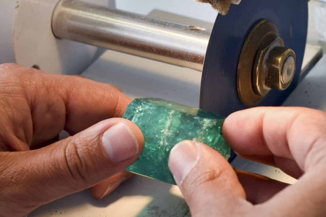 A worker cuts an emerald at the workshop of Muzo Emerald Company in Bogota. Colombian emeralds are considered to be the most beautiful in the world. Photo: AFP