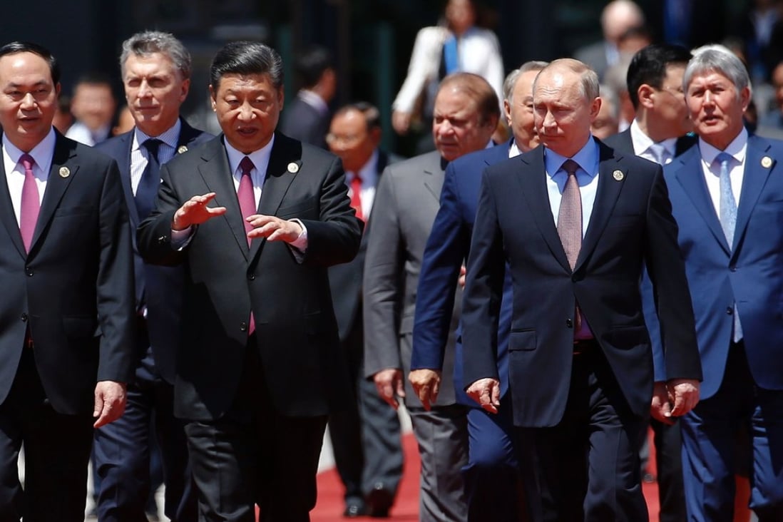 President Xi Jinping (second from left) walks with Vietnamese President Tran Dai Quang and Russian President Vladimir Putin to have a group photo at the International Conference Centre in Yanqi Lake, north of Beijing, yesterday. Photo: AFP