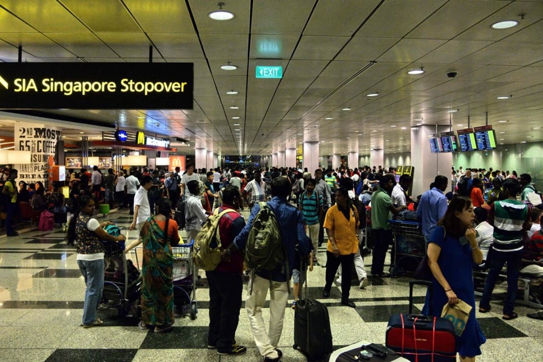 Passengers gather at Changi International Airport terminal 3 after being evacuated from terminal 2 due to a fire. Photo: AFP