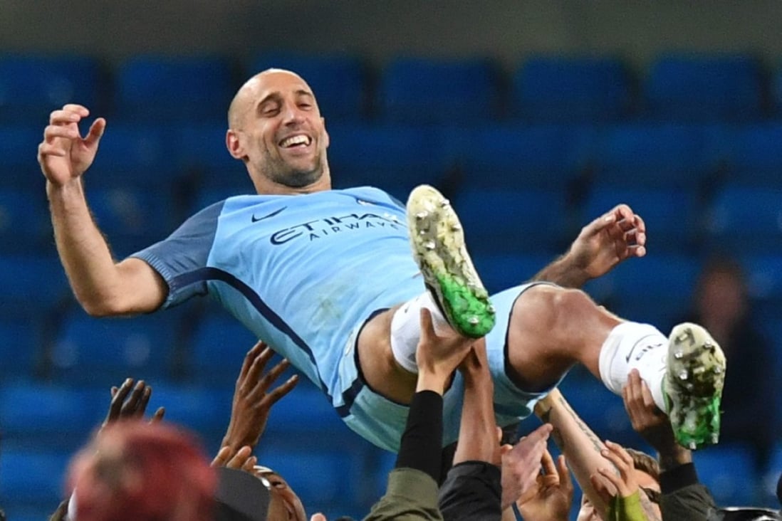 Manchester City veteran Pablo Zabaleta is thrown in the air by his teammates as they and the crowd pay him tribute for his final home appearance for the club. Photo: AFP