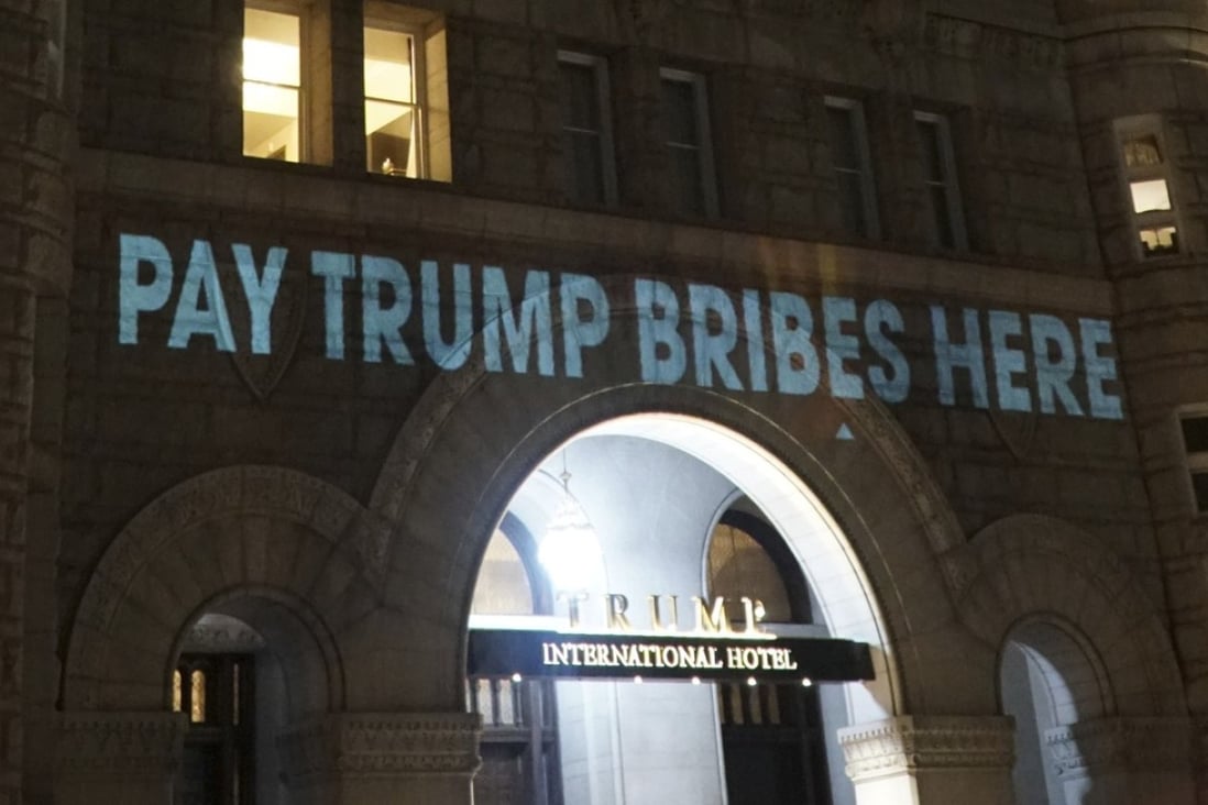 In this photo provided by Liz Gorman aken on Monday, May 15, 2017, President Donald Trump’s Washington hotel is briefly illuminated with projected messages by Robin Bell, a Washington-based artist and filmmaker. Bell says he used a video projector to splash the words across an entrance to the hotel in protest of what he called Trump’s foreign ties. He says the projector ran for about 10 minutes before a security guard asked him to stop. Photo: Liz Gorman via AP