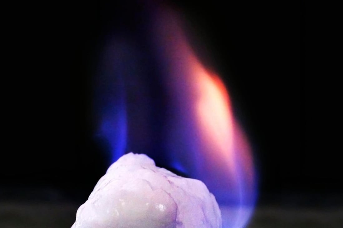 A burning chunk of methane hydrate, or ‘flammable ice.’ China has successfully tested a production system to extract the methane gas and convert it to natural gas on a rig at sea. Photo: Alamy