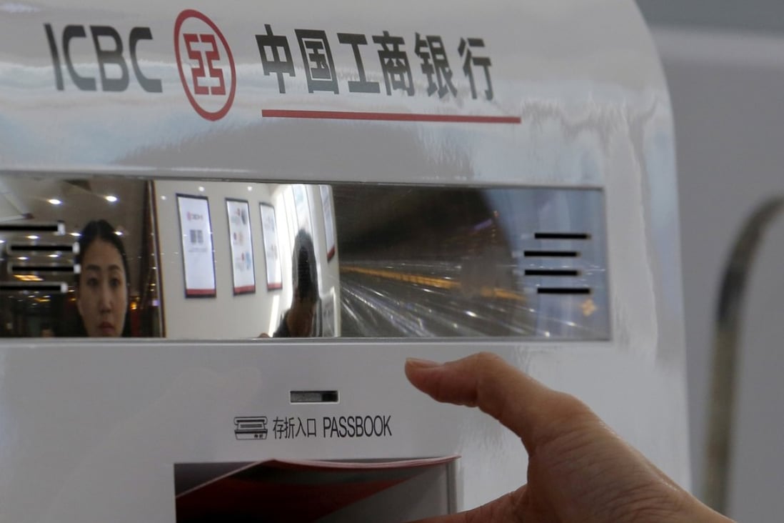 A customer takes her bankbook from a smart banking machine at a branch of ICBC bank in Beijing, China. Net foreign exchange sales by Chinese bank touch a three-month high in April. Photo: Reuters