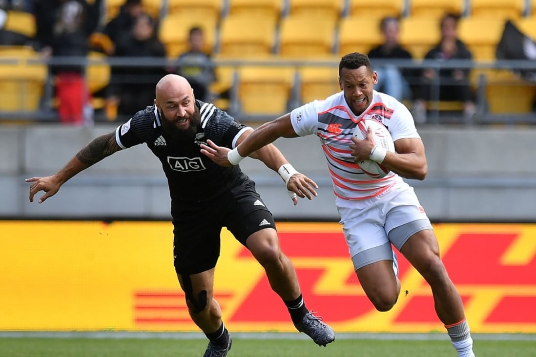 England's Dan Norton is chased by New Zealand's DJ Forbes with empty seats in the background at the 2017 Wellington Sevens. Photos: AFP