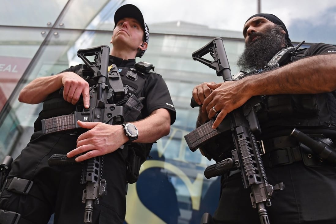 Armed police on patrol in Manchester. Up to 5,000 armed troops can be deployed at transport hubs and other crowded public places in order to release the armed police for other duties. Photo: EPA