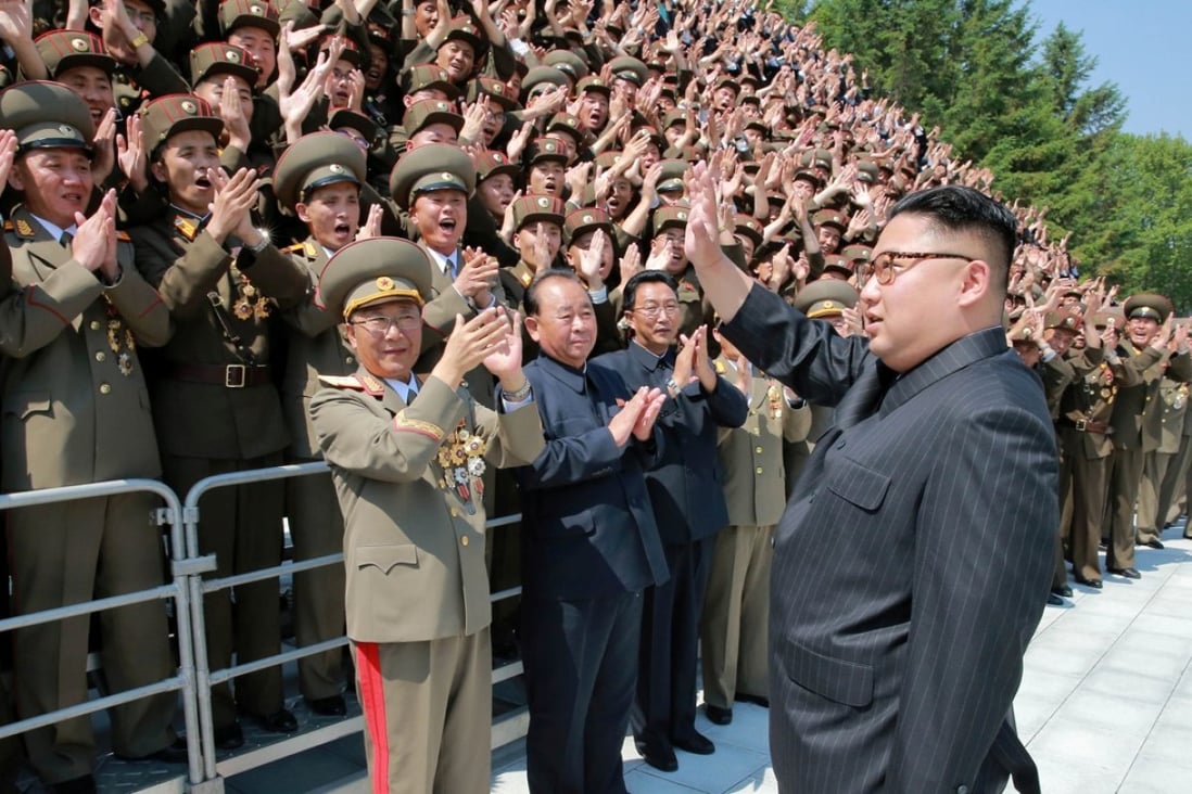 North Korean leader Kim Jong-un waves to scientists and technicians who helped develop his missile programme. Photo: Reuters