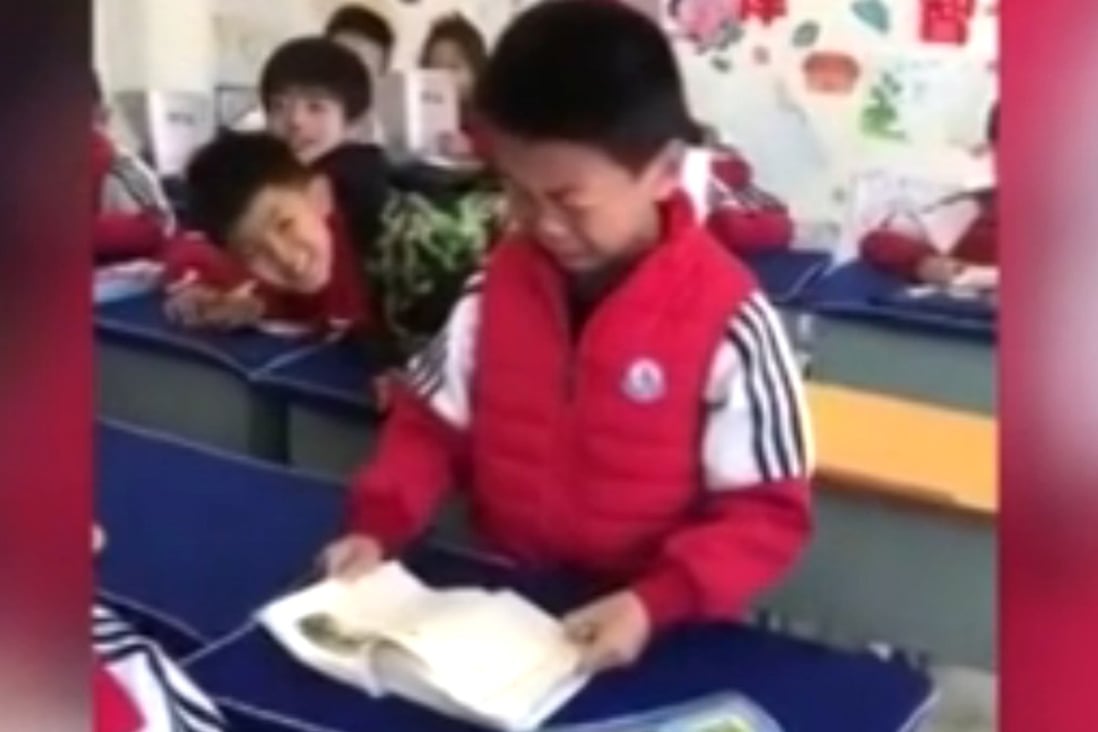 The little boy cries as he reads about Liu Hulan’s death. Photo: Handout