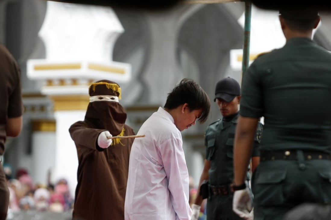 A man is whipped in front of the public as punishment for having gay sex in Banda Aceh, Indonesia. Photo: EPA