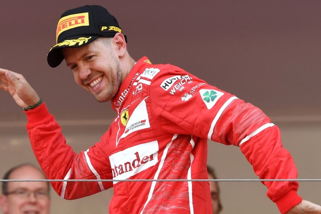 Ferrari's German driver Sebastian Vettel celebrates on the podium after winning the Monaco Formula 1 Grand Prix at the Monaco street circuit. Photo: AFP