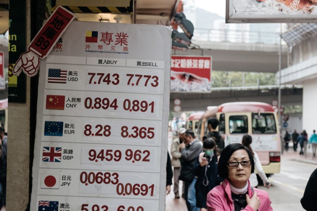 Pe sign listing the exchange rate of the US dollar at a Professional Foreign Currency Exchange Ltd store in Hong Kong. Photo: Bloomberg