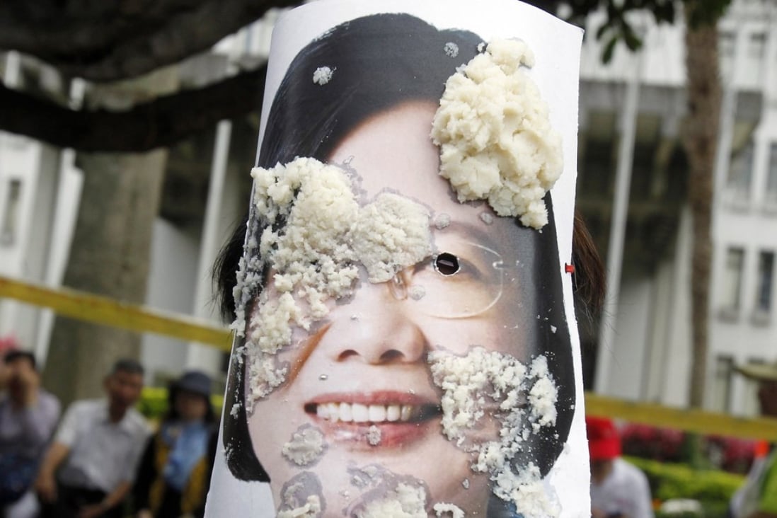 A person wearing a photo of Taiwan's President Tsai Ing-wen is covered by bean curd during a Labour Day rally in Taipei. Beijing has frosty relations with Tsai, suspecting that she wants formal independence for Taiwan.