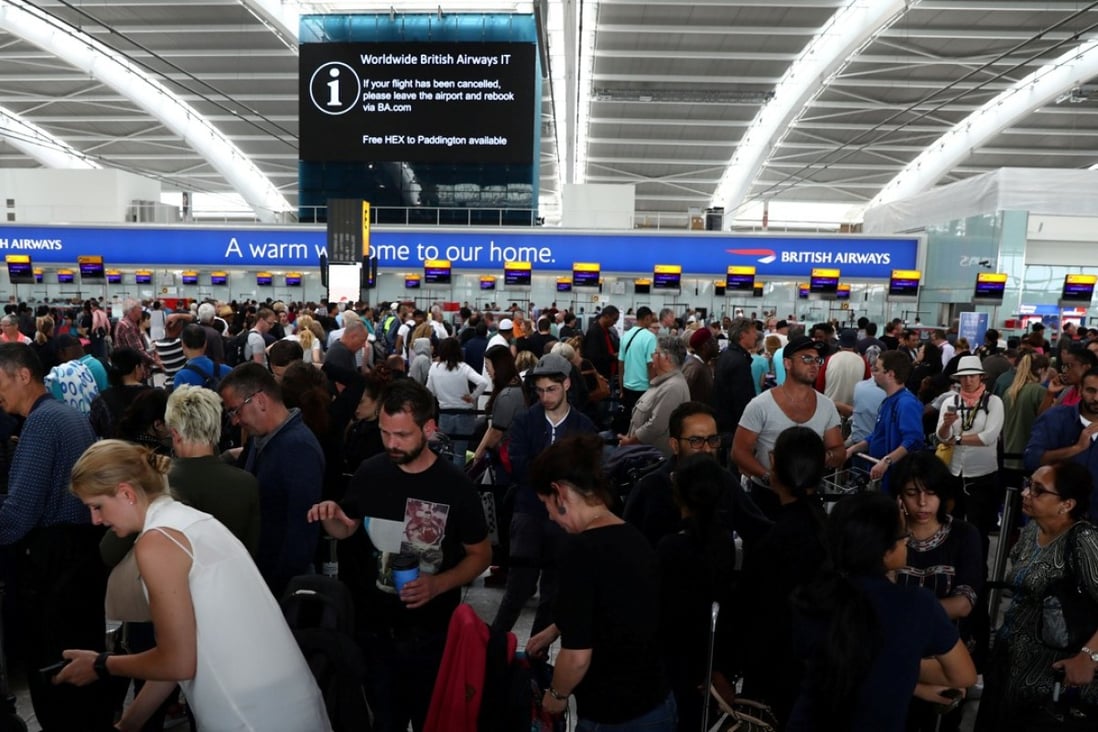 People wait with their luggage at the British Airways check-in desks at Heathrow Terminal 5 in London. Photo: Reuters