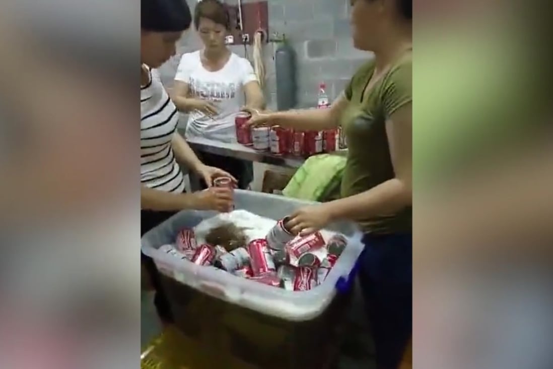 Workers shown in the video putting beer into used cans. Photo: Handout