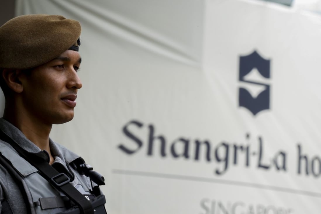 An armed police officer stands in front of the logo of the Shangri-La Hotel, the venue of the International Institute for Strategic Studies (IISS) 16th Asia Security Summit in Singapore, 02 June 2017. Photo: EPA