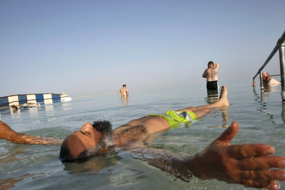 An ultra-Orthodox Jewish man floats in the Dead Sea, where the high salinity creates extra buoyancy. Photo: Handout