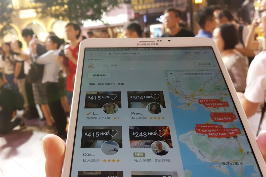 A tourist is checking the Airbnb app with his mobile device in Causeway Bay. Photo: Martin Chan