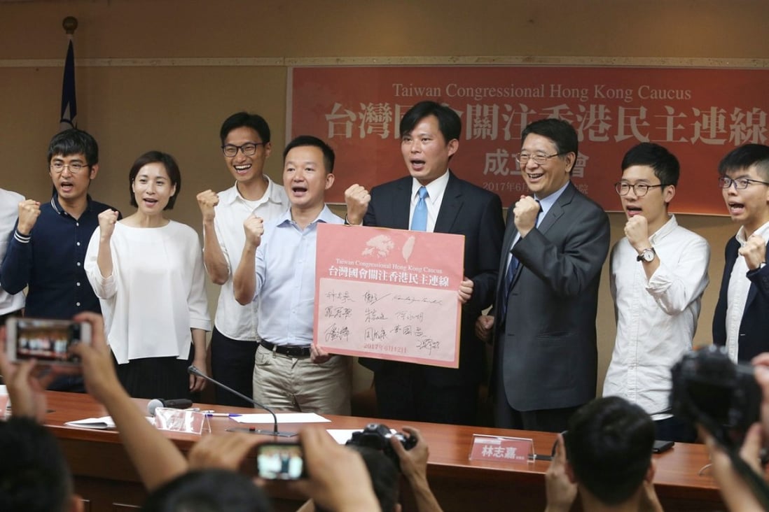 Huang Kuo-chang (fourth from right) with Alex Chow (second left), Eddie Chu (fourth left), Raymond Chan (fifth left), Nathan Law (second right), Joshua Wong (right) and other Taiwanese legislators at the platform launch. Photo: CNA