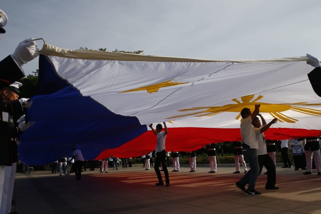 Philippine Marines prepare to raise the Philippine flag to celebrate the 119th anniversary of Philippine independence. Photo: AP