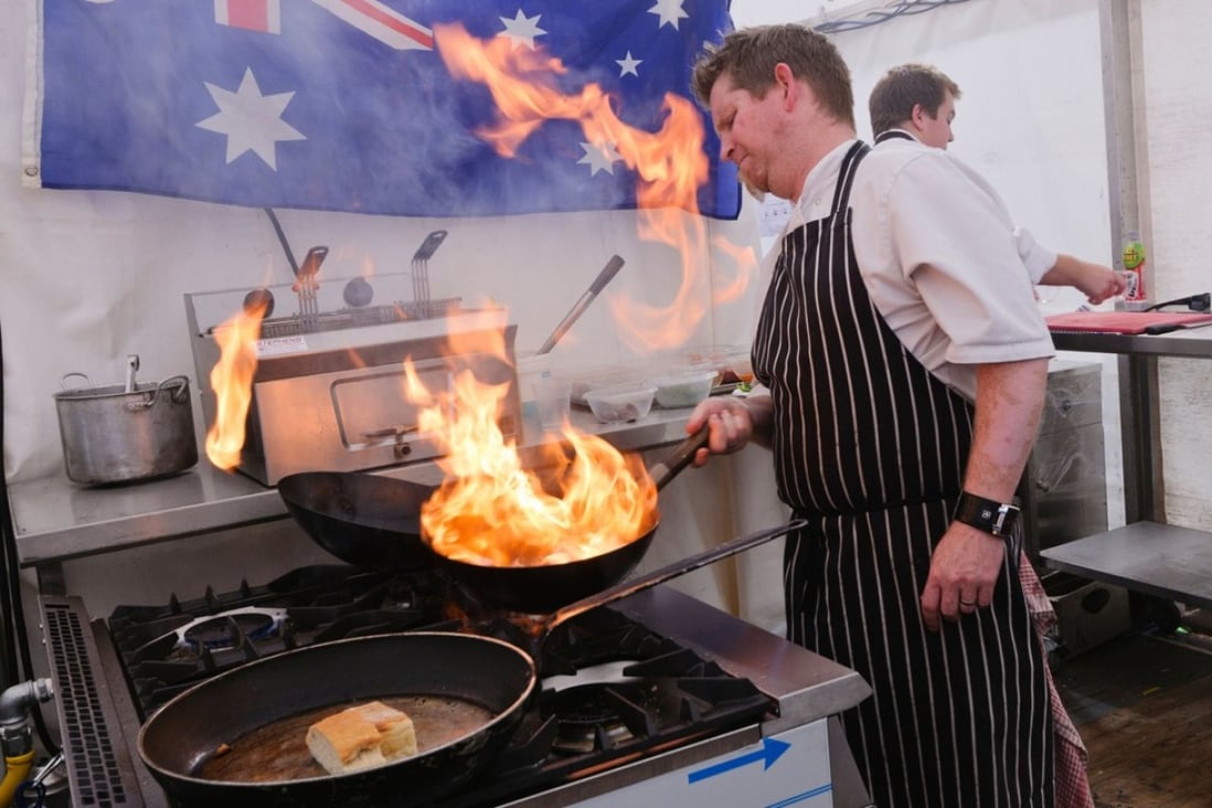 A chef flambéing kangaroo steaks. Picture: Alamy