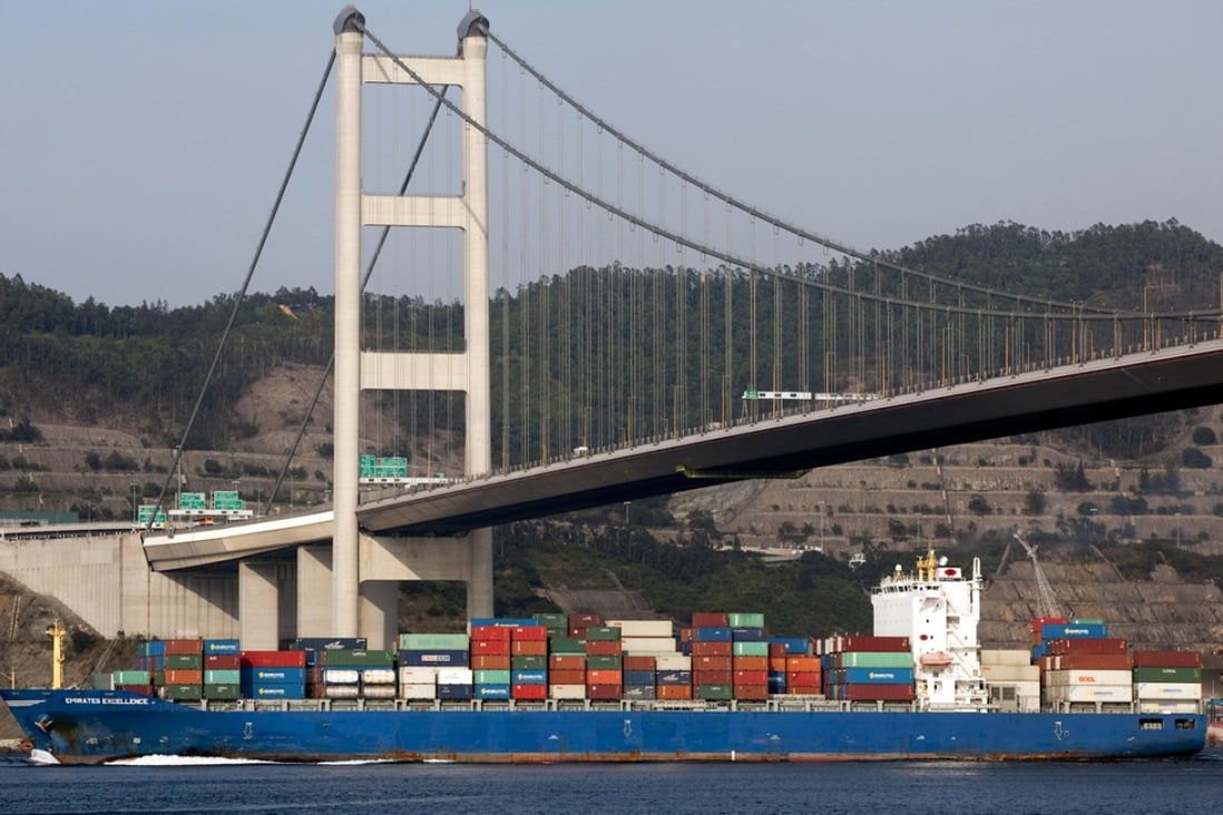 A container ship passes under the Tsing Ma Bridge in Hong Kong. Photo: Bloomberg