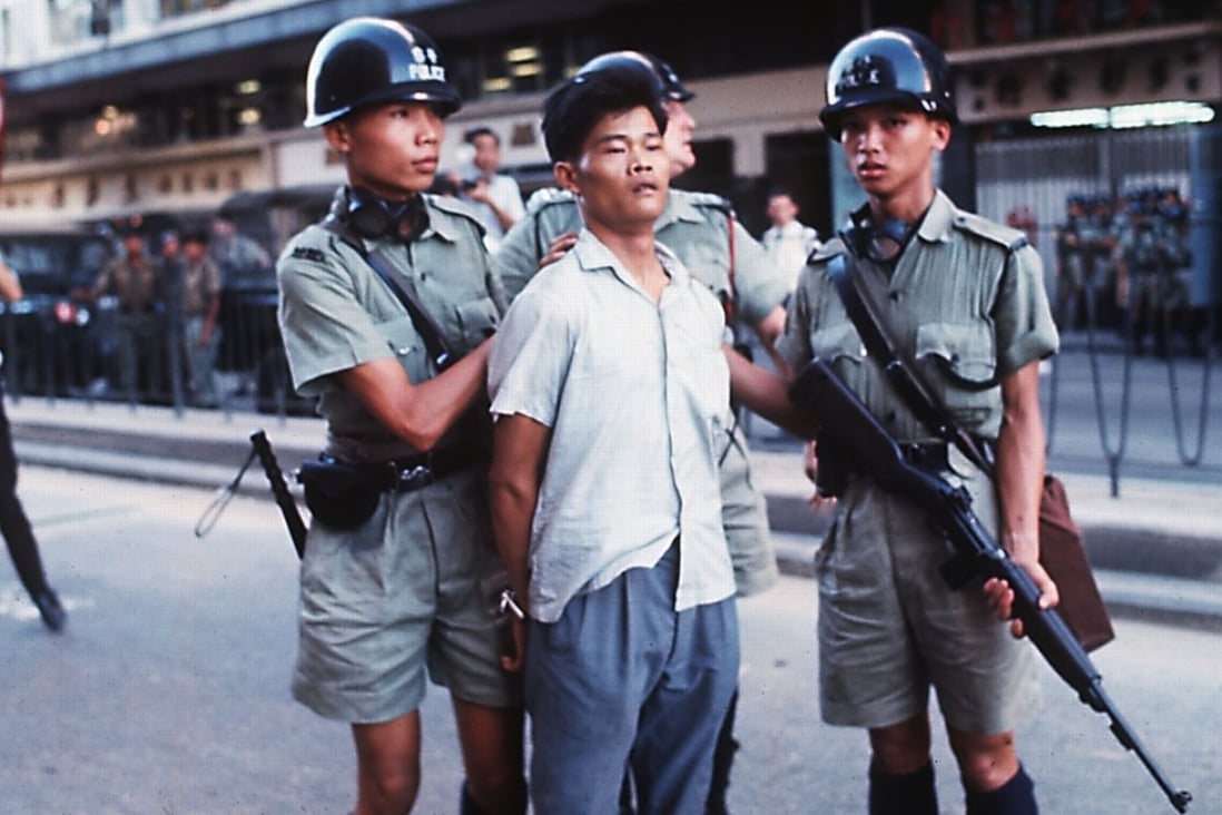 A man is taken into custody by police during the 1967 riots in Hong Kong.