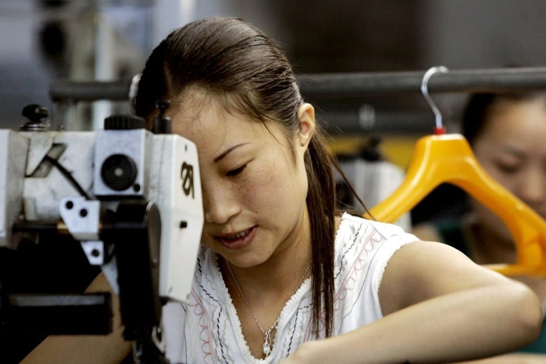Workers make garments at a clothing manufacturer in Ningbo in Zhejiang province. Photo: EPA