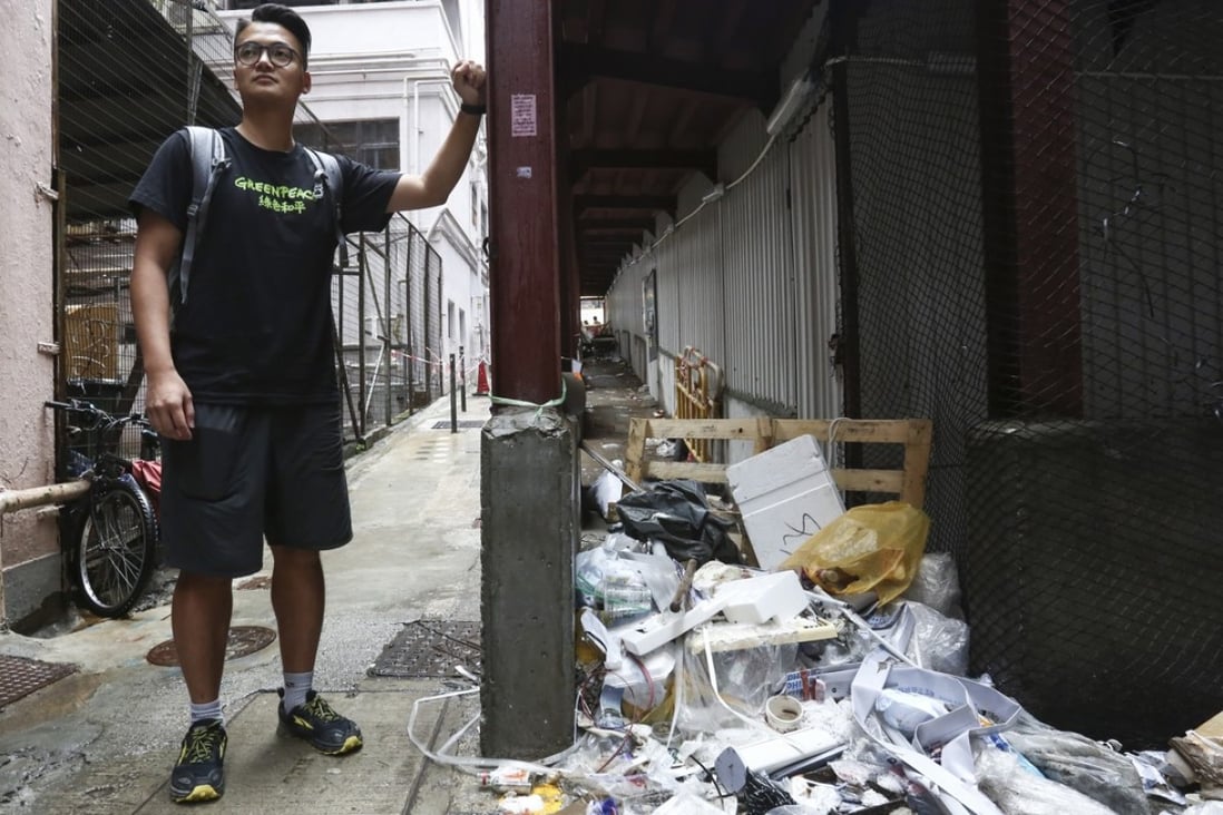 Greenpeace campaigner Andy Chu stands next to a trail of trash in Wan Chai, highlighting the problem of overconsumption in Hong Kong. Photo: Jonathan Wong