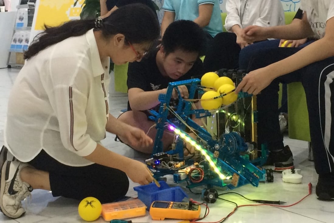 Teammates make final adjustments to their robot at Makeblock’s makeathon in Shenzhen, China, Photo: Coco Liu