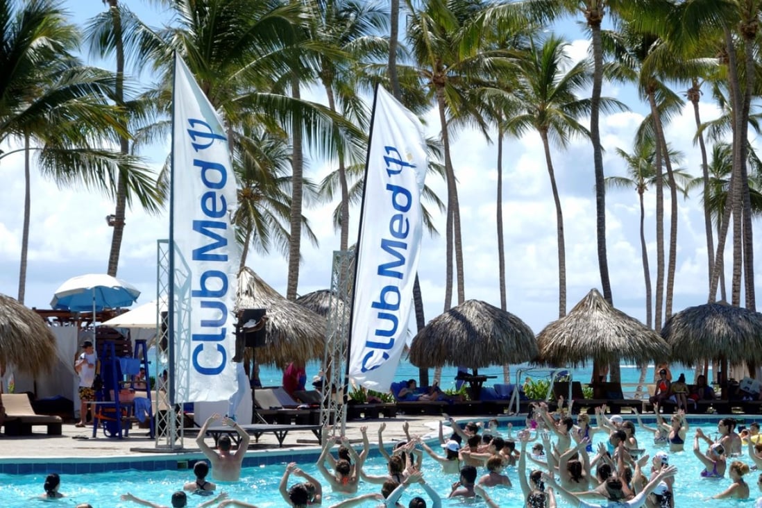 FILE PHOTO: Club Med banners blow in the wind beside the swimming pool at the Club Med Punta Cana vacation resort in the Dominican Republic, March 3, 2016. REUTERS/Charles Platiau/File Photo