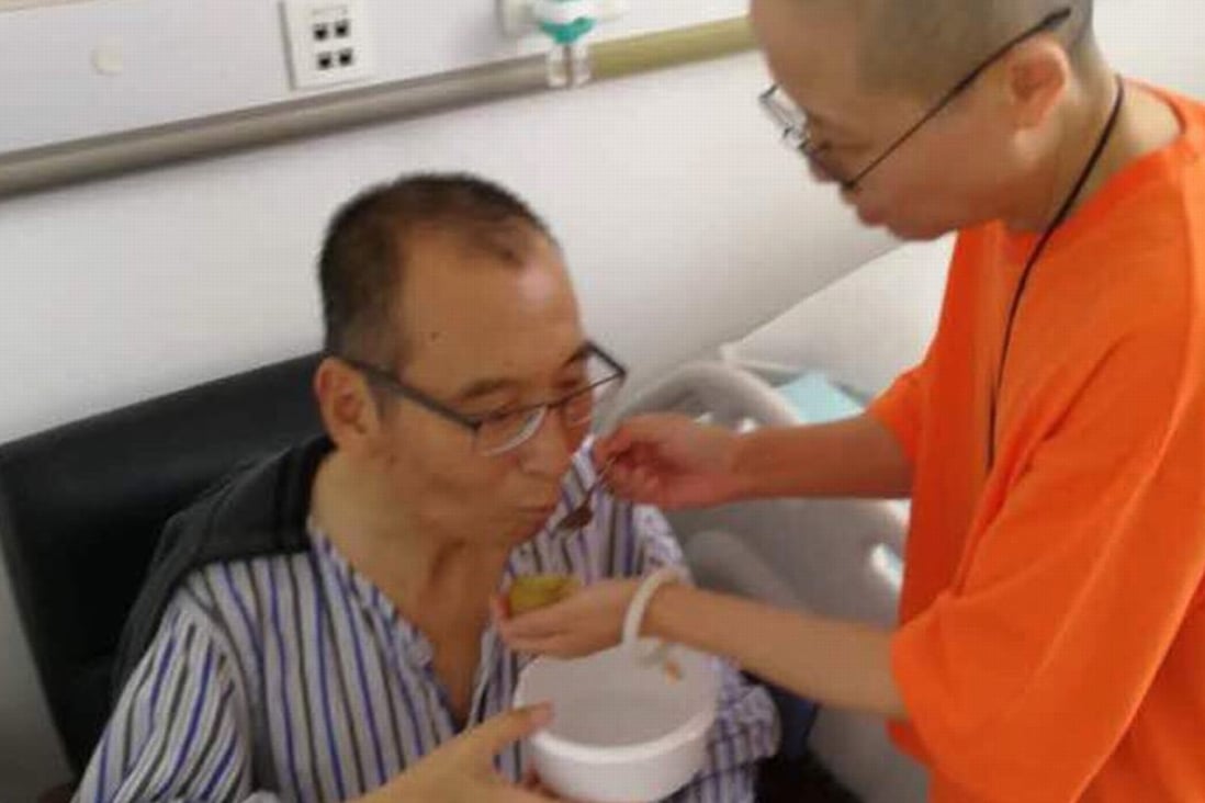 In an undated photo, Chinese dissident Liu Xiaobo is attended to by his wife Liu Xia in a hospital in China. Photo: AP