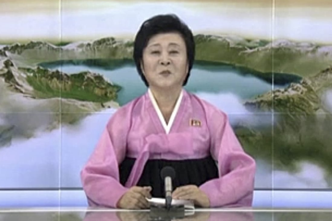 A North Korean television presenter announces the test launch of the country’s first intercontinental ballistic missile. Photo: KRT