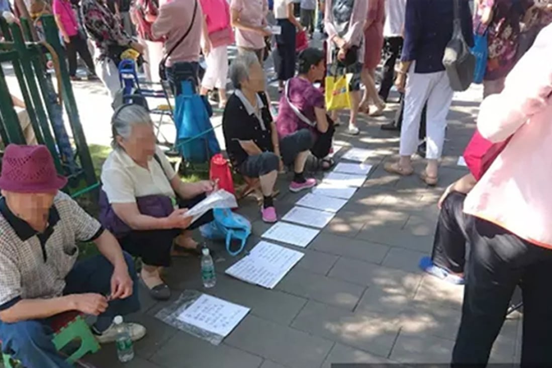 Beijing parents offer details about their unwed children on pieces of paper in the quest for a perfect match. Photo: Phoenix Weekly