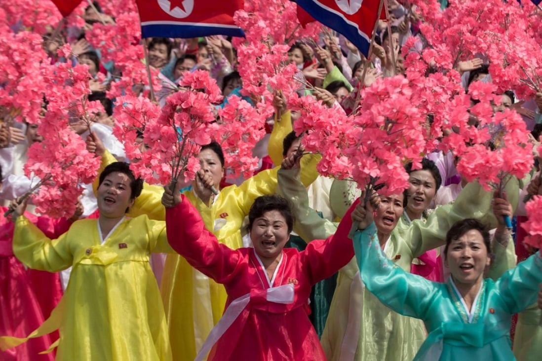 Women in traditional dress wave flowers and shout slogans as they pass North Korea’s leader Kim Jong-un during a mass rally marking the 105th birth anniversary of his grandfather and the nation’s founder, Kim Il-sung, in Pyongyang on April 15. Photo: AFP