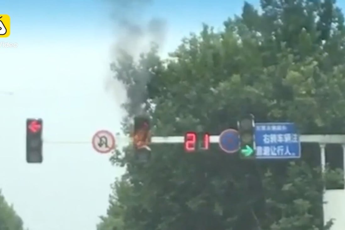 What a scorcher! Traffic light bursts into flames in eastern China