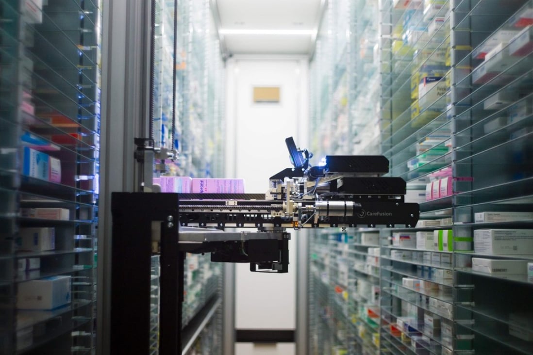 This file photo taken on July 23, 2013 shows a robot retrieving medicines in the pharmacy of the Argenteuil hospital, in Argenteuil, a Paris suburb. Technology has long impacted the labour force, but recent advances in artificial intelligence and robotics have heightened concerns on automation replacing a growing number of occupations including highly skilled or "knowledge-based" jobs. Photo: AFP