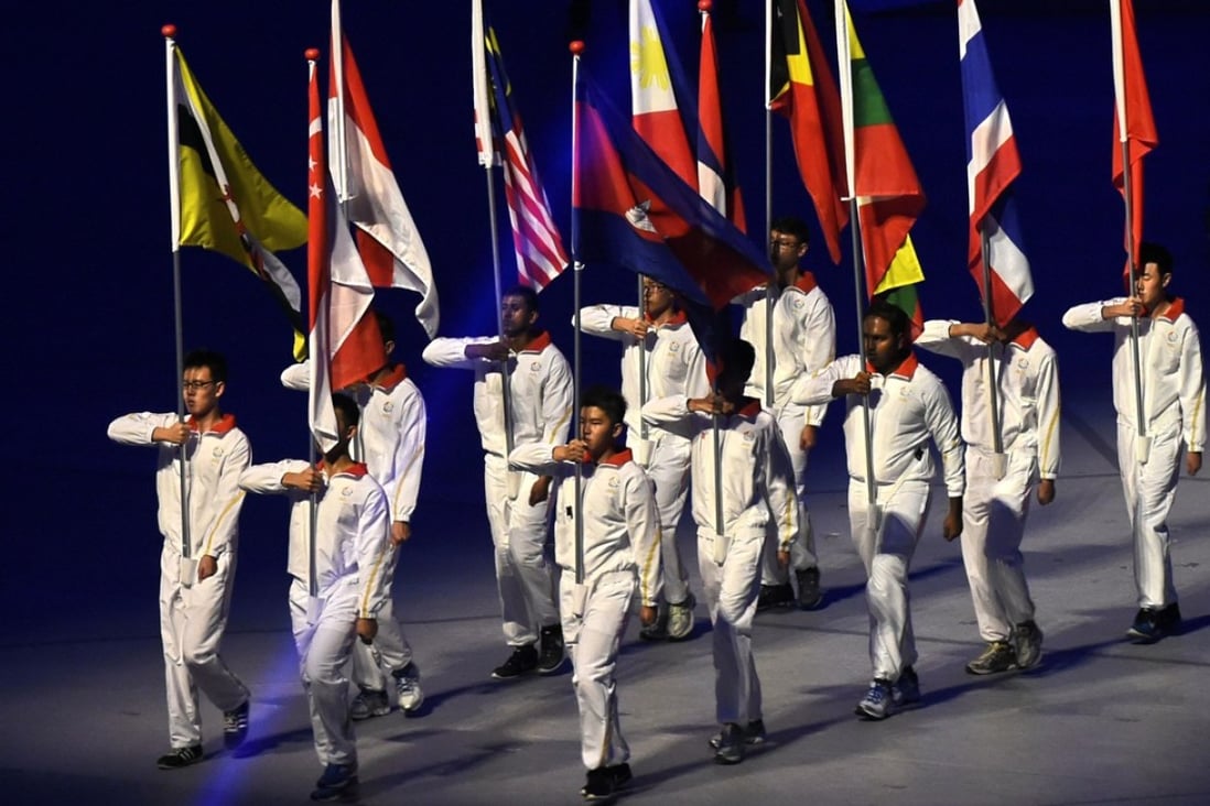 Flag-bearers from the participating countries march in the opening ceremony of the 2015 Southeast Asian Games, in Singapore on June 5 that year. The biennial event will be hosted by Malaysia in August this year. Photo: AFP