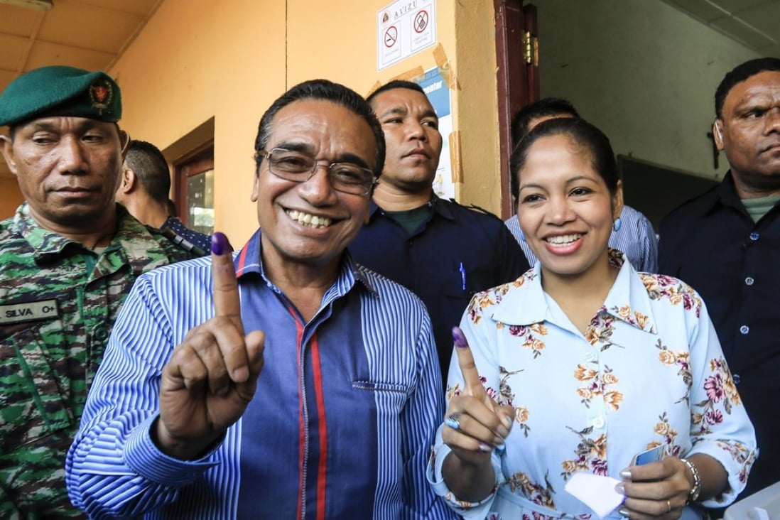 East Timorese President Francisco Guterres and first lady Cidalia Mozinho show their marked fingers shortly after casting their votes. Photo: EPA