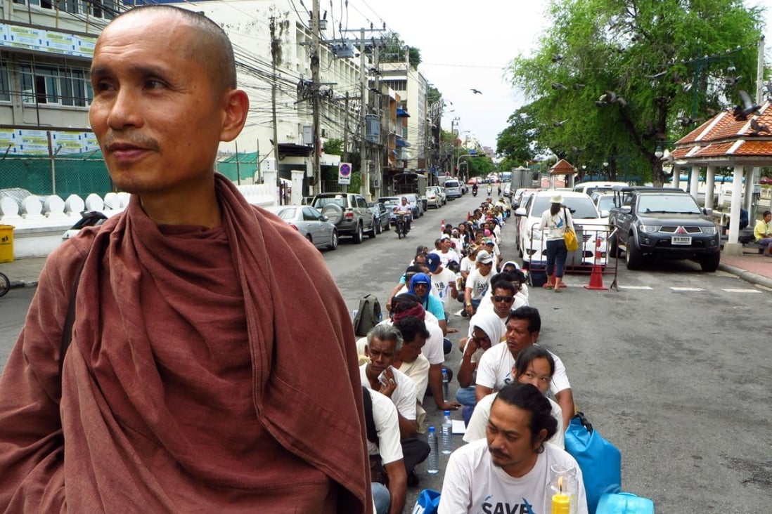 Dadodin Patavatto a Buddhist monk, leads a silent march to the prime minister's office in Bangkok to demonstrate against a proposed coal power plant in southern Thailand. The plans for an 800-megawatt coal power plant have sparked an outcry in the typically tranquil Krabi province, famed for its white sand and picturesque limestone cliffs. Photo: AP