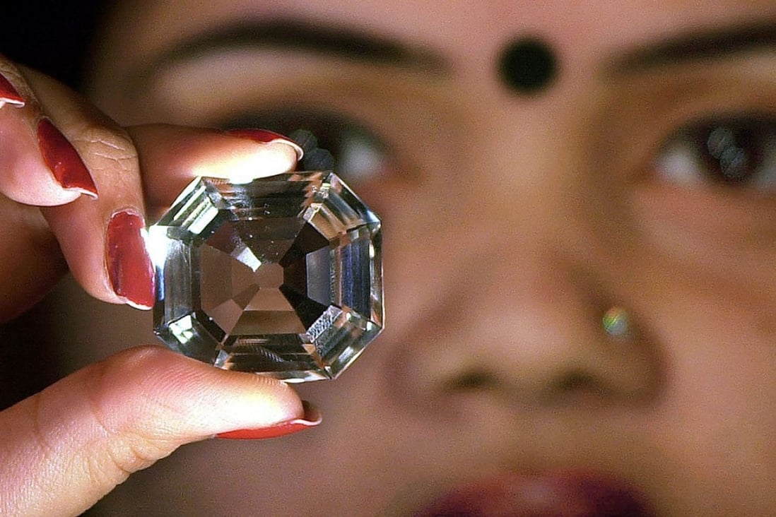 An Indian model holds a replica of the Koh-i-Noor diamond. Photo: AFP