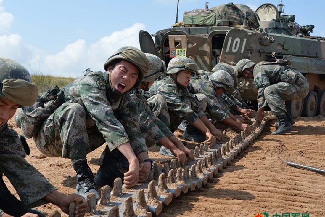PLA soldiers prepare to fit a tank track at the Zhurihe training base in Inner Mongolia. Photo: SCMP Pictures