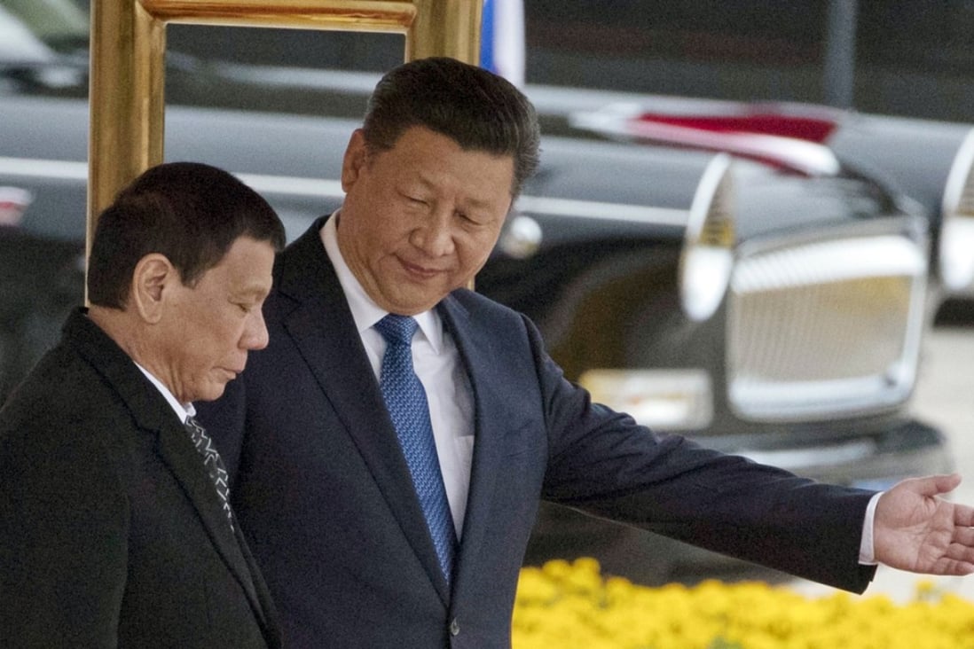Chinese President Xi Jinping, right, shows the way to Philippine President Rodrigo Duterte during a welcome ceremony last year outside the Great Hall of the People in Beijing. Photo: Associated Press